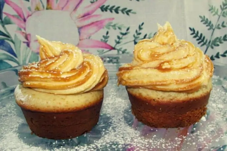 Vanilla Cupcakes Topped with a Swirl of Caramel Cream Cheese Icing